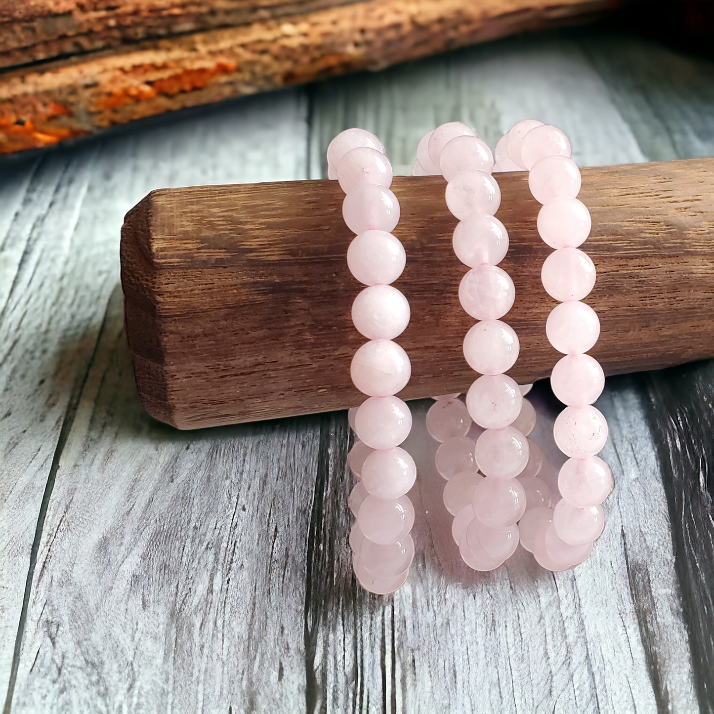 Rose Quartz Bracelet featuring 8mm beads on stretchy string for a 7-inch wrist. They are a soft pink. A blend of elegance and mysticism, radiating the soothing energies of rose quartz. Perfect accessory for love, healing, and positive vibes.