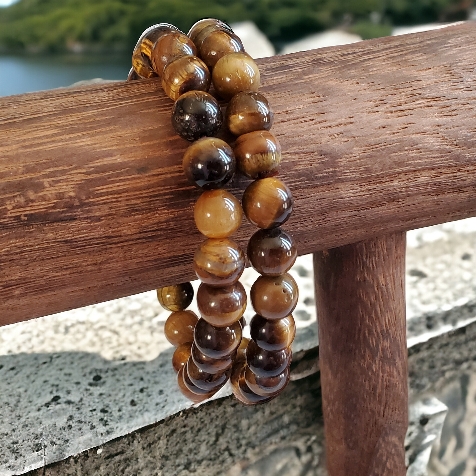 Tiger Eye Bracelet showcasing 8mm beads on stretchy string, tailored for a 7-inch wrist. A harmonious fusion of golden brown hues radiating strength and confidence. The perfect accessory for an empowered and stylish look.